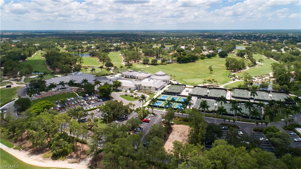 Aerial overview of property's location featuring a golf course and a nearby body of water