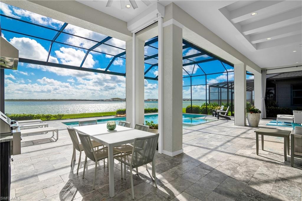 View of patio with a sunroom, an outdoor pool, a lanai, a water view, and outdoor dining space
