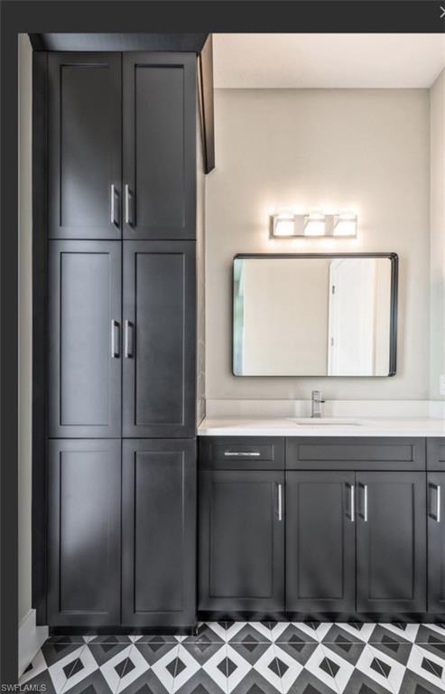 Bathroom featuring vanity and tile patterned floors