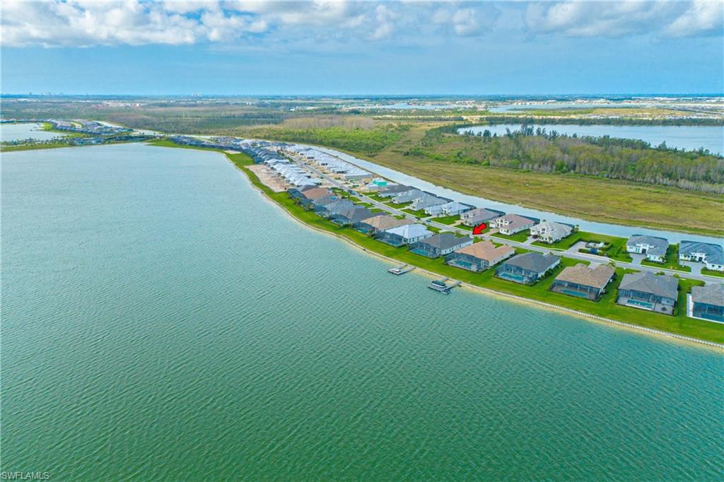 Aerial perspective of suburban area with a nearby body of water