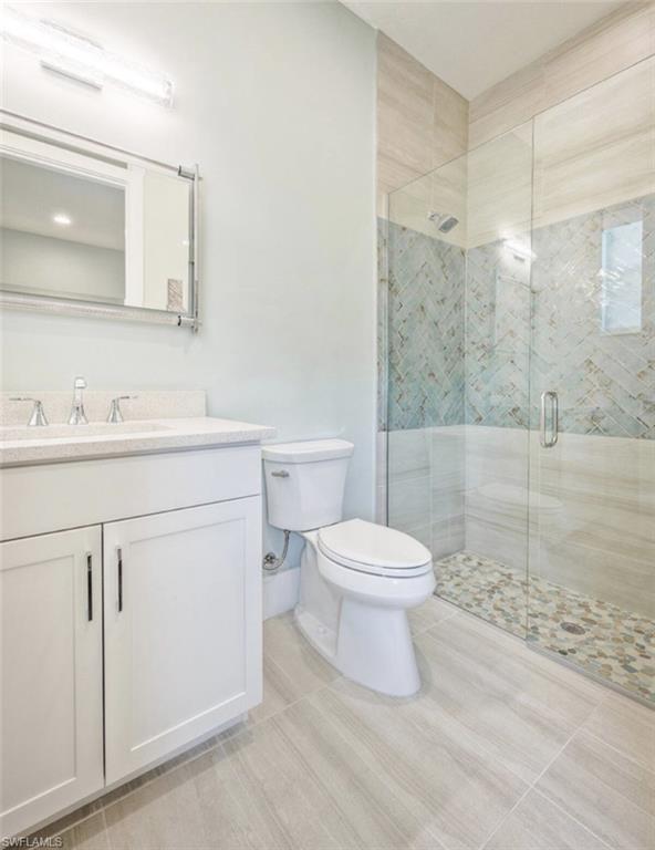 Bathroom with a stall shower and vanity