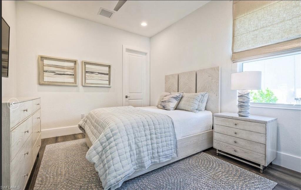 Bedroom with baseboards and dark wood finished floors