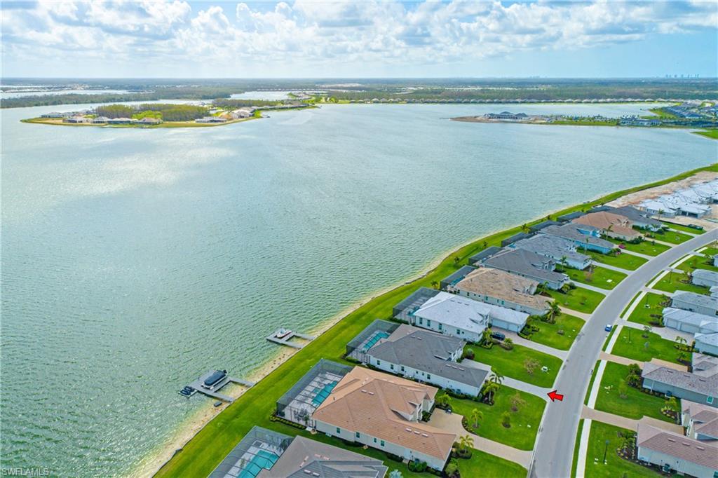 Aerial view of residential area featuring a large body of water