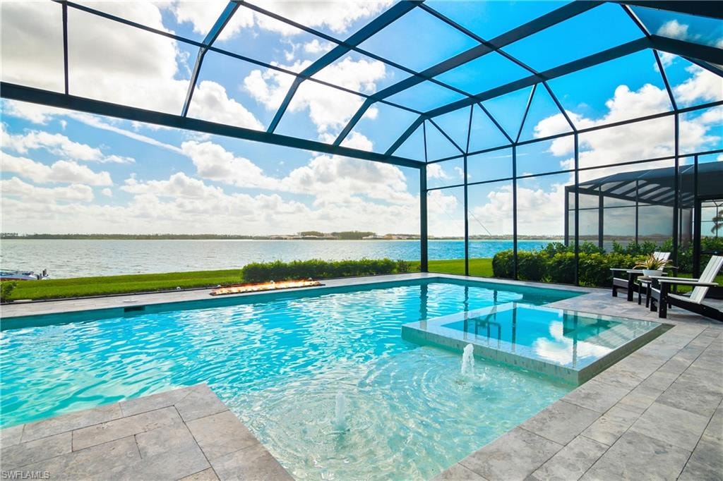 View of pool featuring a pool with connected hot tub, a lanai, a water view, a sunroom, and a patio area