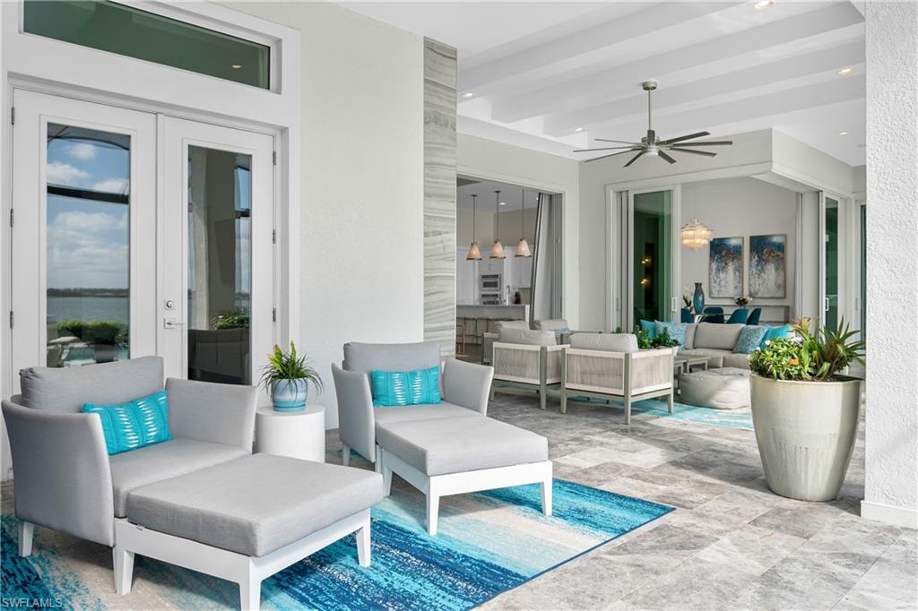 View of patio with an outdoor living space and ceiling fan