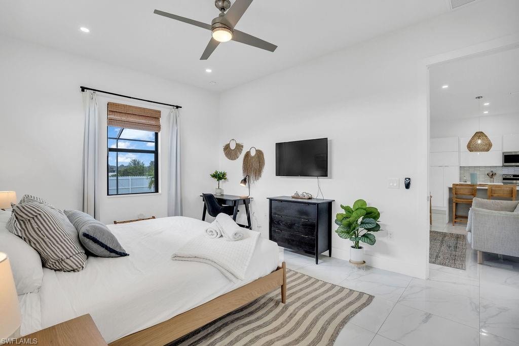 Bedroom with light marble finish floors, a ceiling fan, and recessed lighting