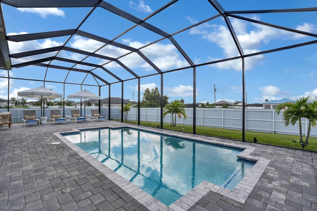 View of swimming pool featuring a lanai, a sunroom, a fenced backyard, and a patio