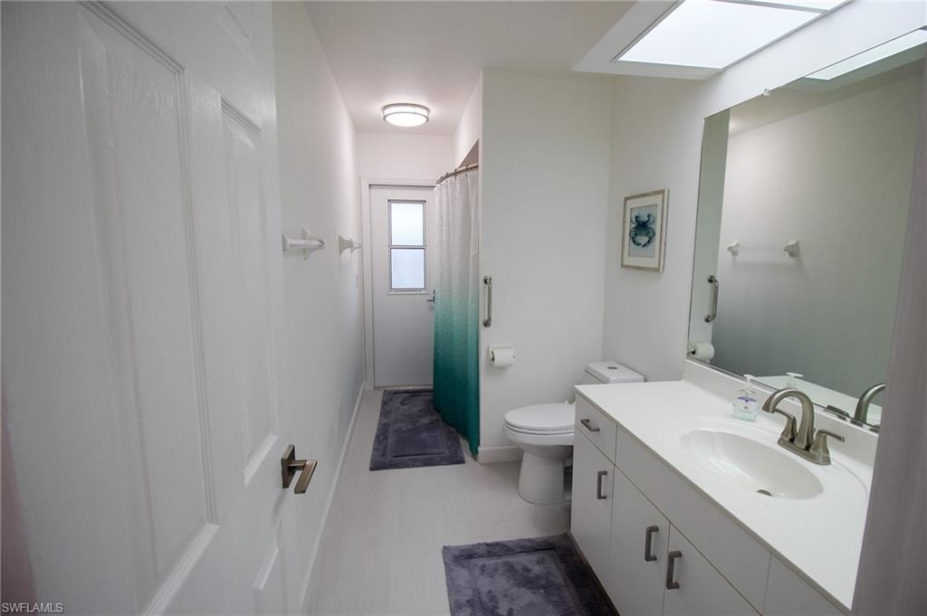 Full bath with door leading to lanai/pool
