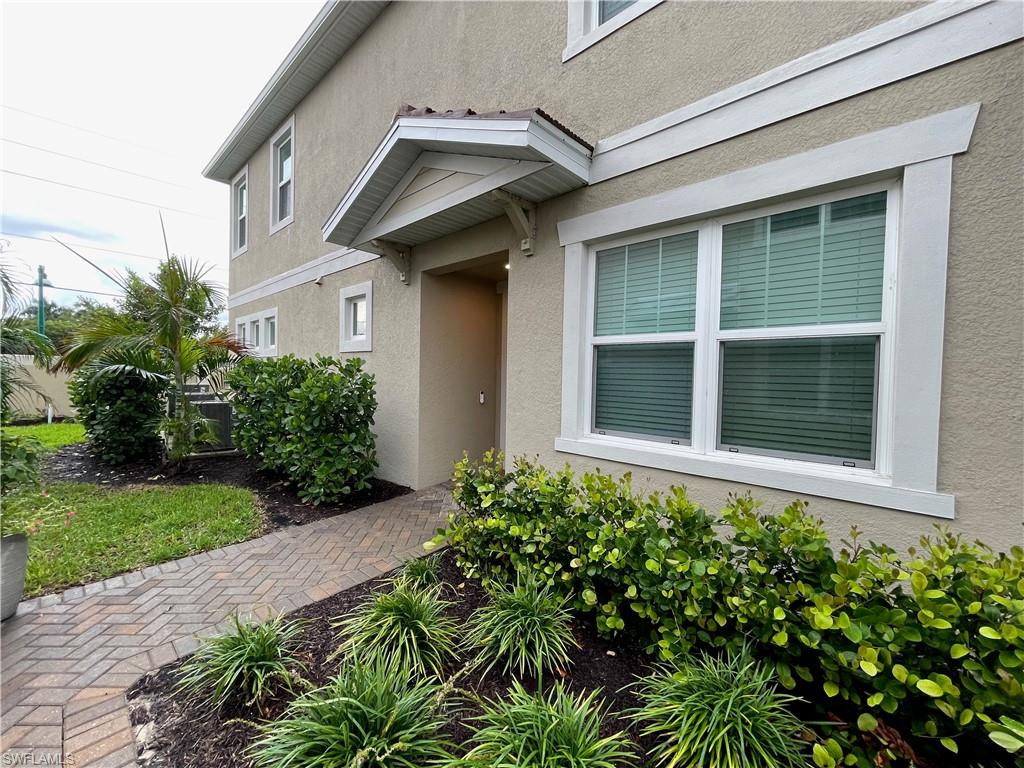 Property entrance with stucco siding