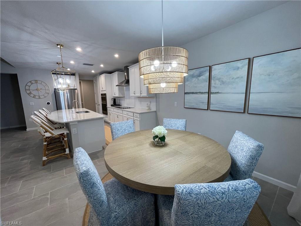 Dining room featuring a chandelier and recessed lighting