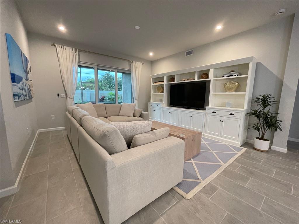 Living area with recessed lighting and baseboards