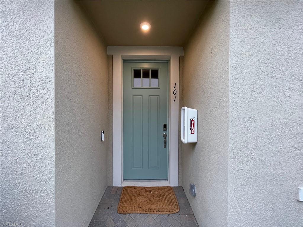 Property entrance featuring stucco siding