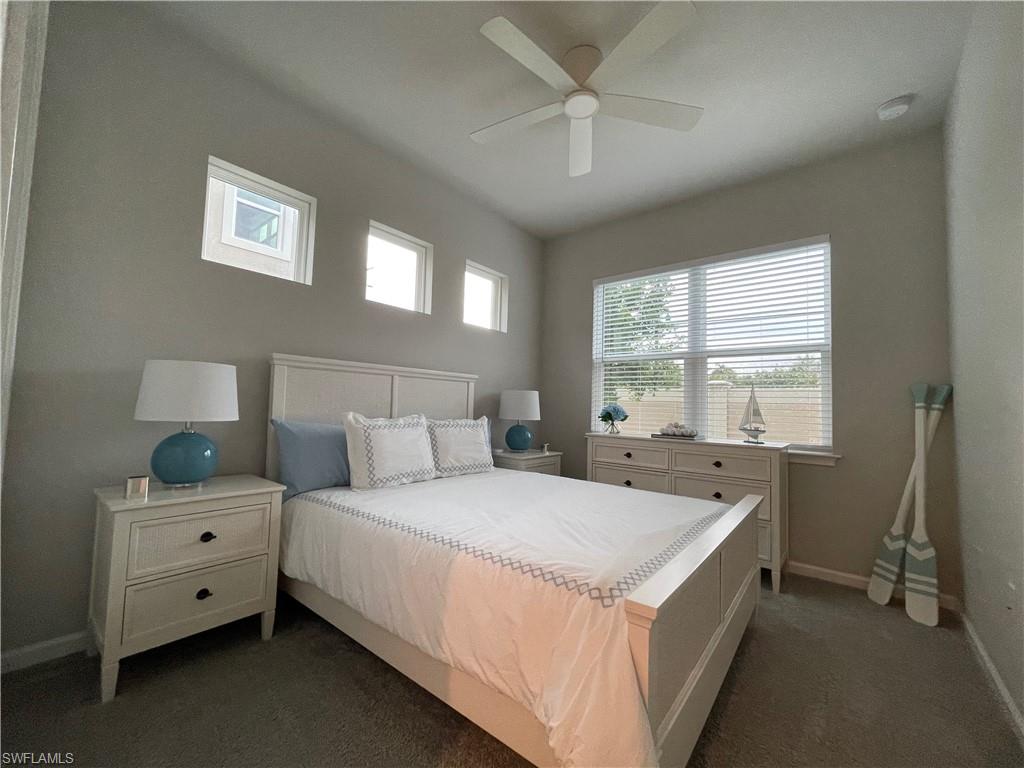 Bedroom featuring dark carpet and ceiling fan
