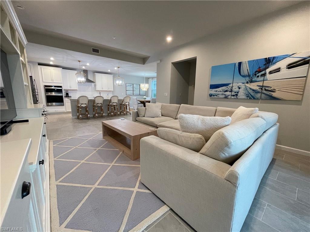 Living room featuring recessed lighting and a chandelier
