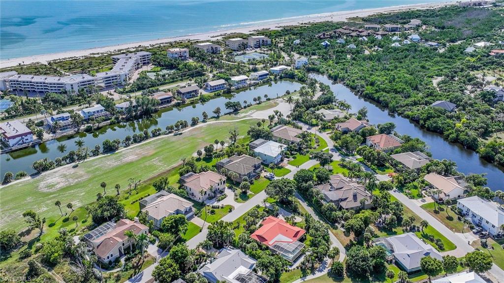 Aerial view of property and surrounding area featuring a large body of water