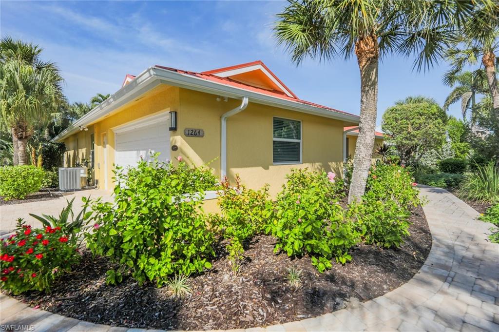 View of property exterior featuring an attached garage and stucco siding