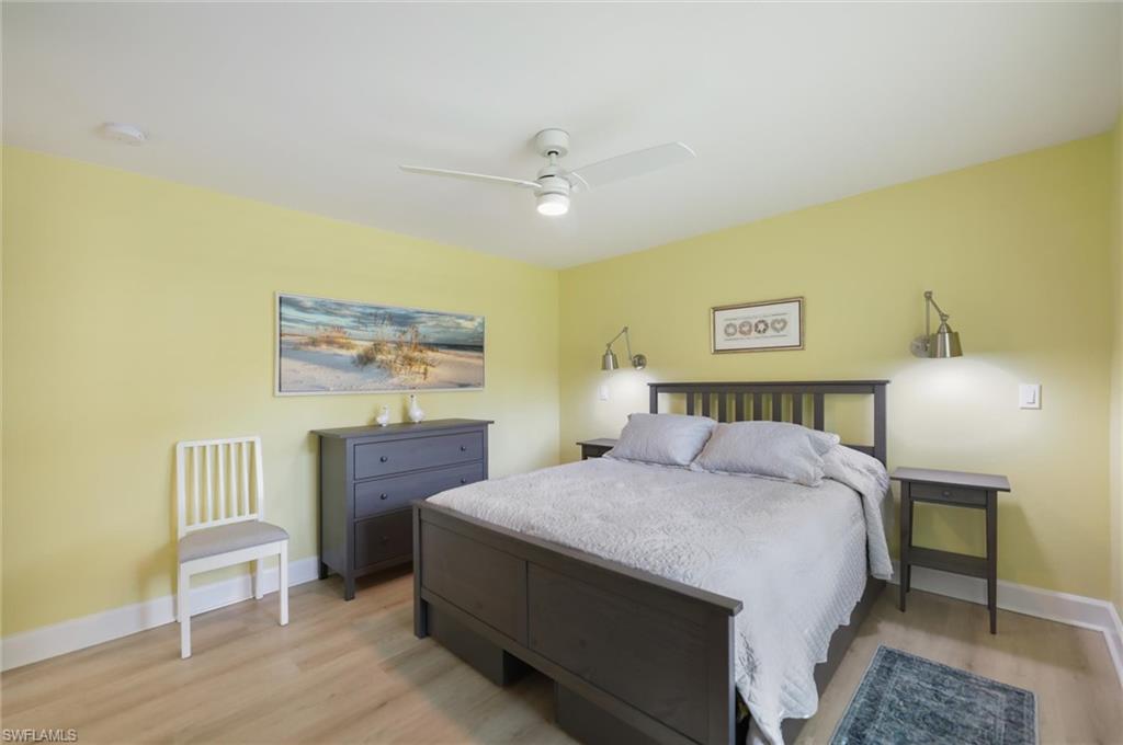 Bedroom with light wood-type flooring and a ceiling fan