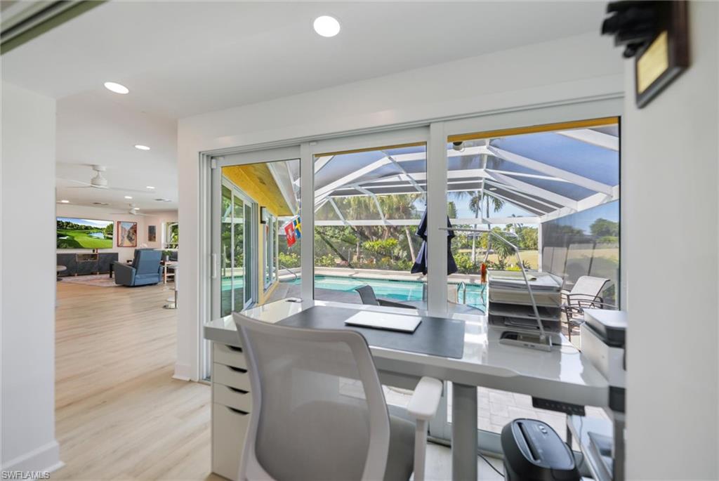 Home office with a sunroom, recessed lighting, plenty of natural light, light wood-type flooring, and a ceiling fan