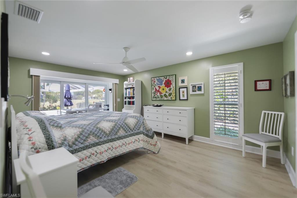 Bedroom featuring access to outside, light wood-style floors, a ceiling fan, and recessed lighting