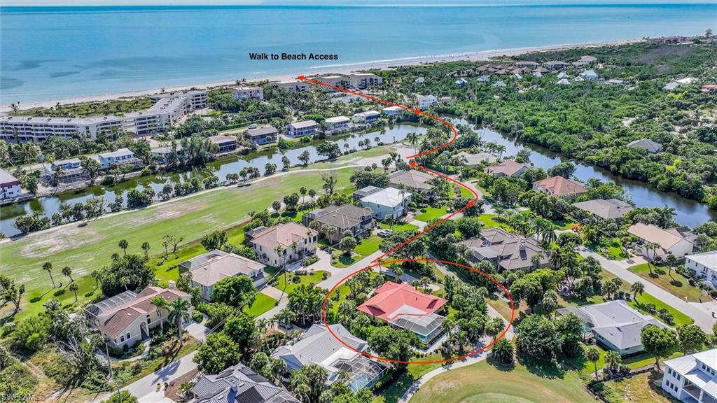 Aerial view of residential area with a golf club and a nearby body of water
