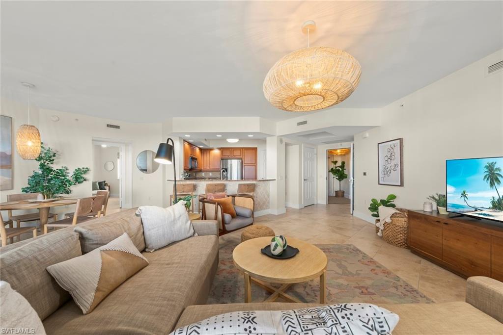 Living room featuring light tile patterned floors and recessed lighting