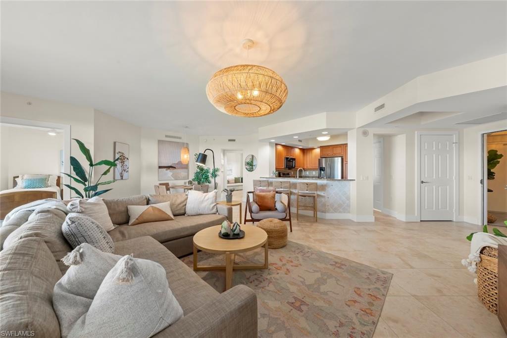 Living room featuring light tile patterned flooring and baseboards