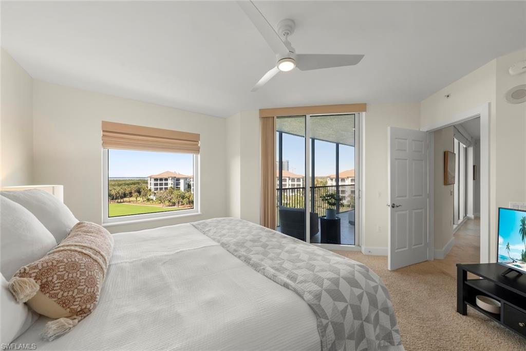 Bedroom featuring access to exterior, light colored carpet, and a ceiling fan