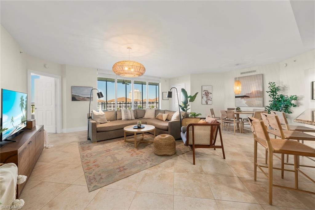 Living area featuring baseboards and light tile patterned flooring