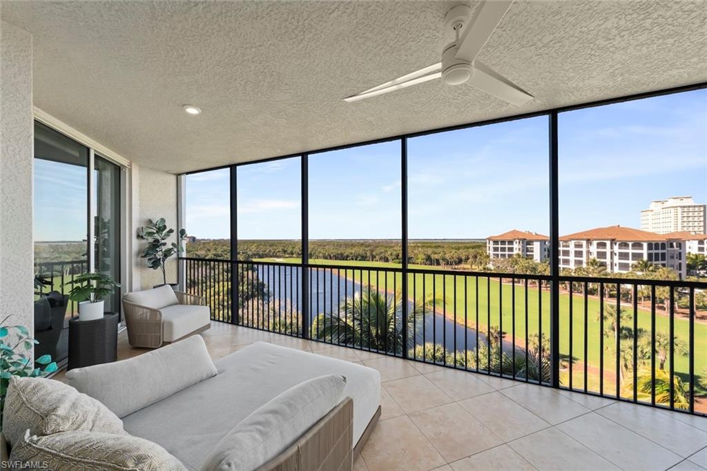 Sunroom with expansive windows, a textured ceiling, and tile patterned floors