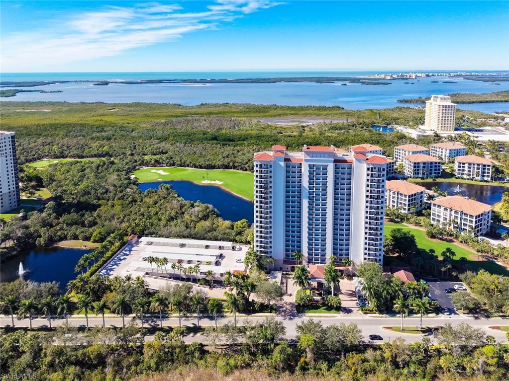 Drone / aerial view of apartment complex and a large body of water