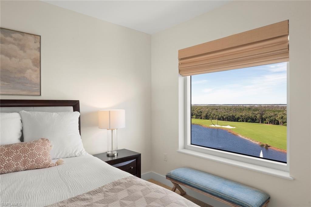 Bedroom with a water view and baseboards