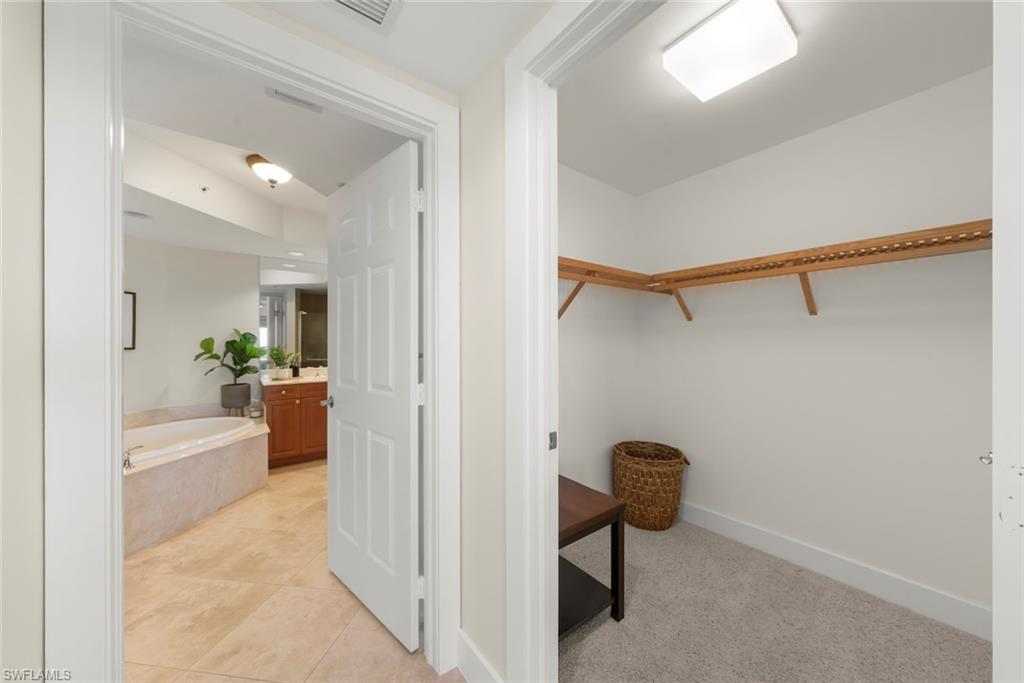 Walk in closet featuring light carpet