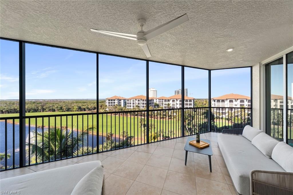 Sunroom with a wall of windows, a textured ceiling, and tile patterned floors