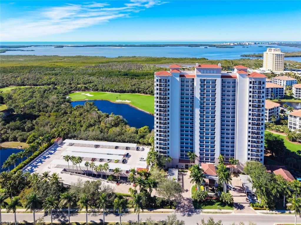 Aerial view of apartment complex and a nearby body of water