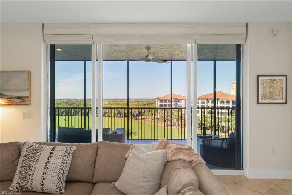 Living area featuring a ceiling fan and baseboards