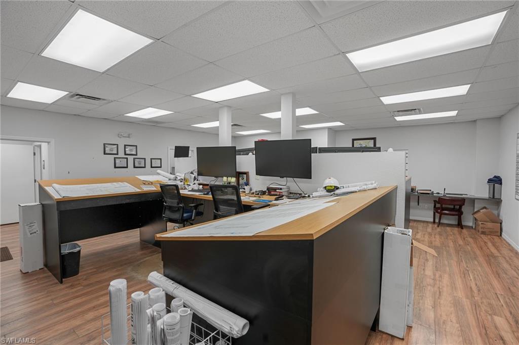 Home office with a drop ceiling and built in desk