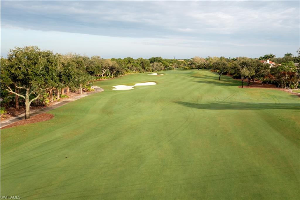 View of property's community with golf course view and view of scattered trees