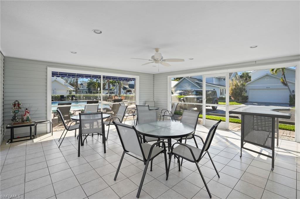 Sunroom with tile patterned floors and wooden walls