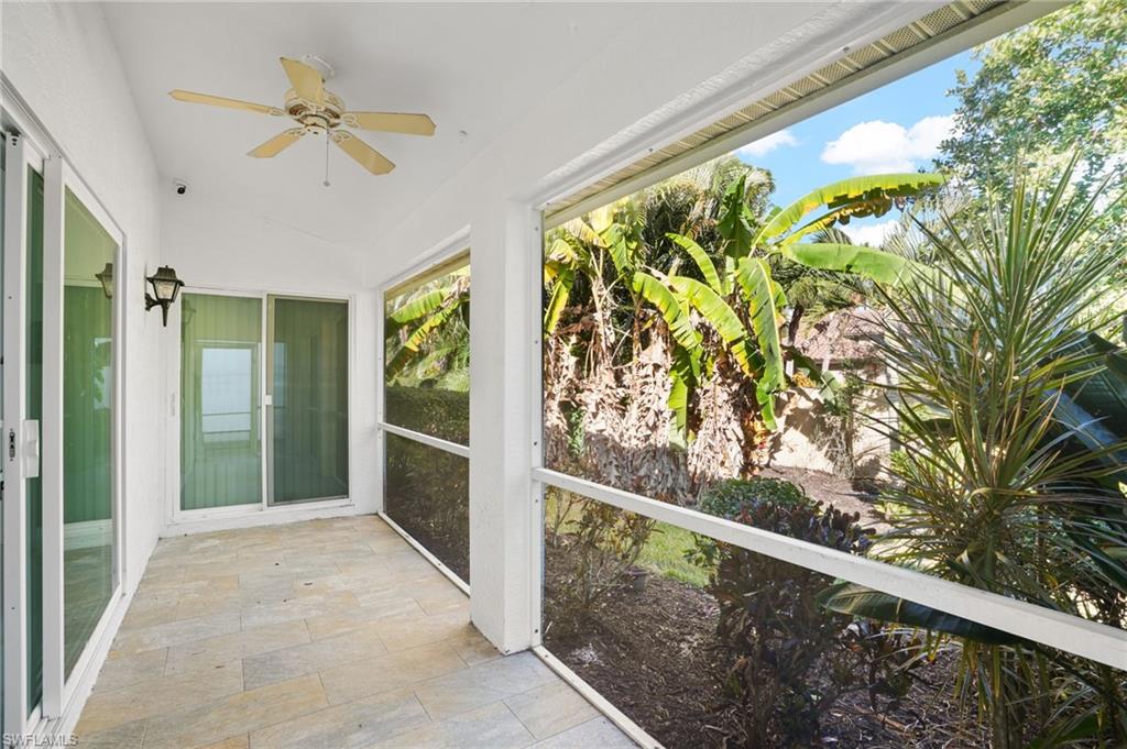Unfurnished sunroom with ceiling fan and vaulted ceiling