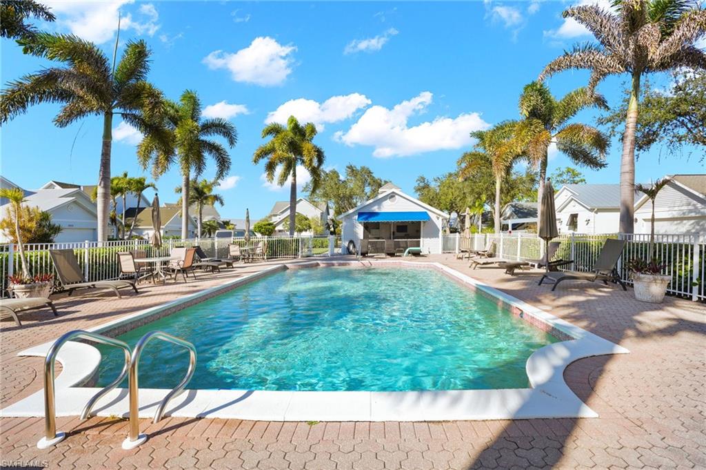 Community pool featuring a patio area and a residential view