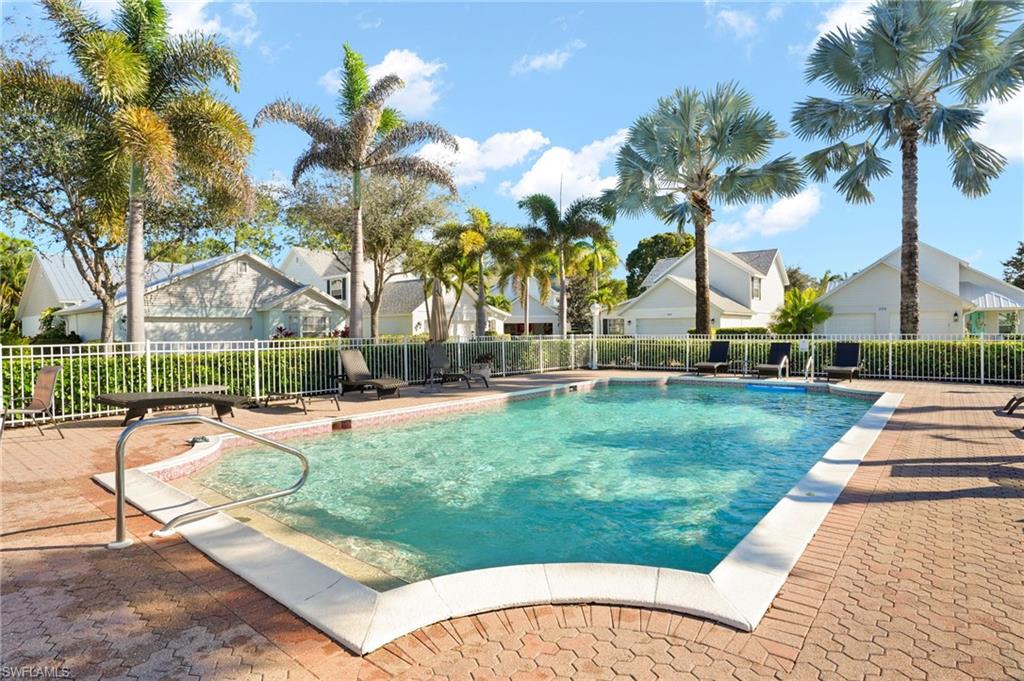 Community pool with a residential view and a patio