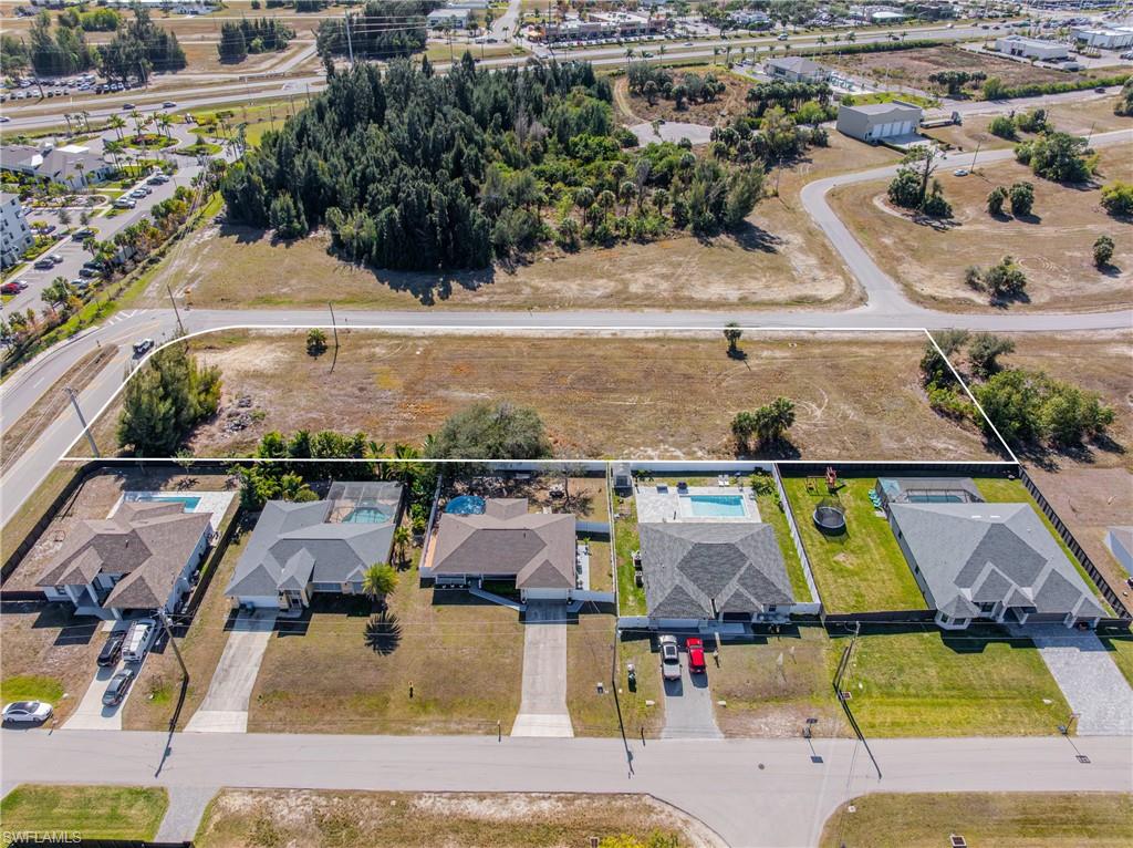 Aerial perspective of suburban area featuring property parcel outlined