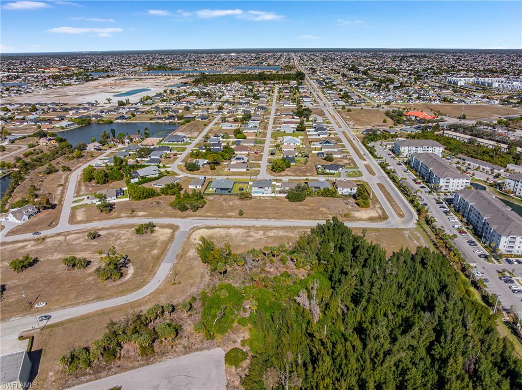 Aerial view of property's location with a large body of water and nearby suburban area