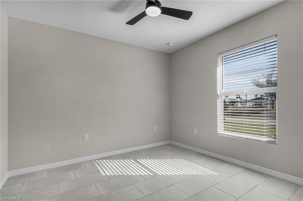 Spare room with baseboards and ceiling fan
