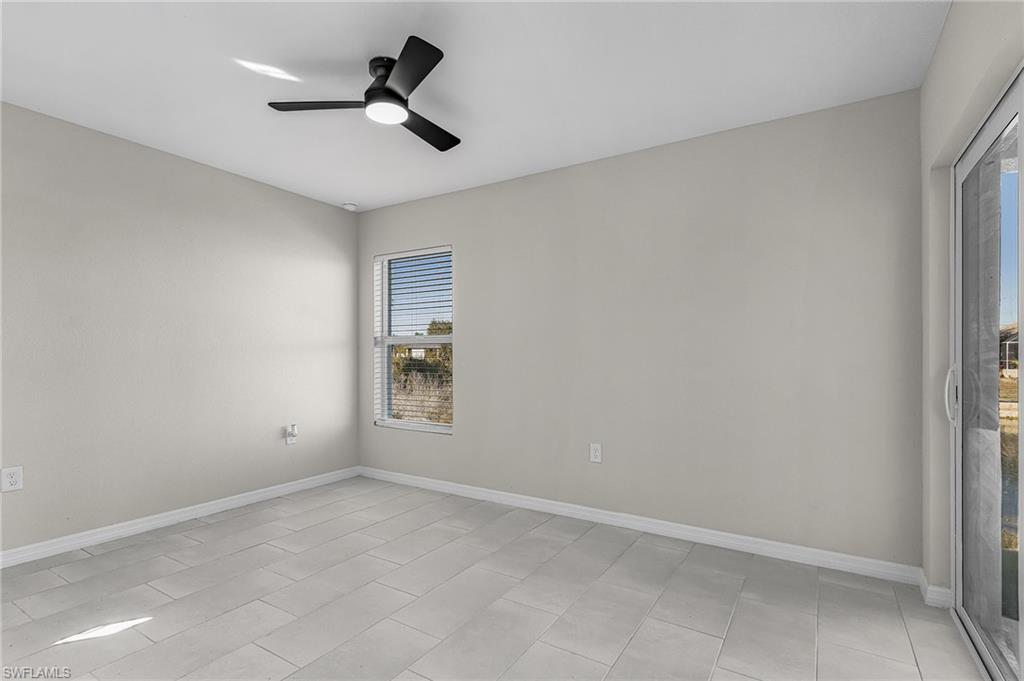 Spare room with baseboards and a ceiling fan