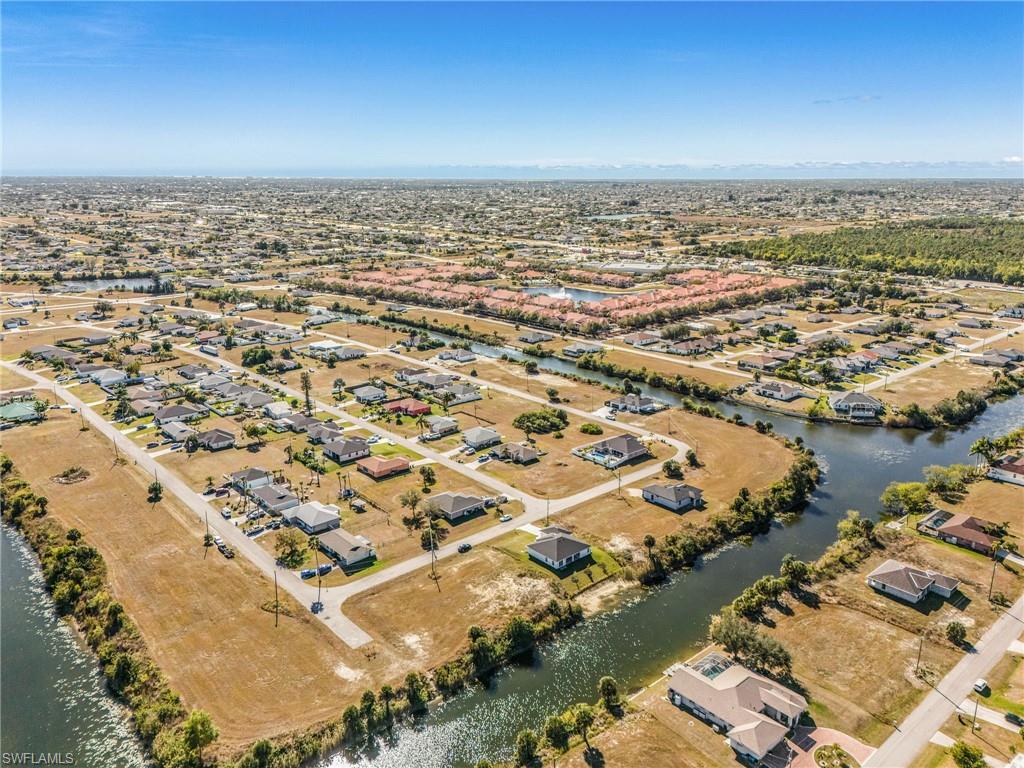 Aerial view of property's location with nearby suburban area and a nearby body of water