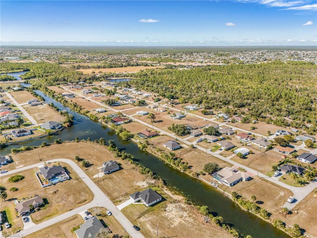 Aerial view of property's location with nearby suburban area and a large body of water