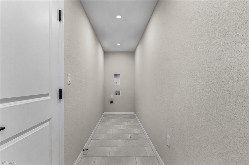 Laundry area with electric dryer hookup, recessed lighting, washer hookup, and tile patterned floors