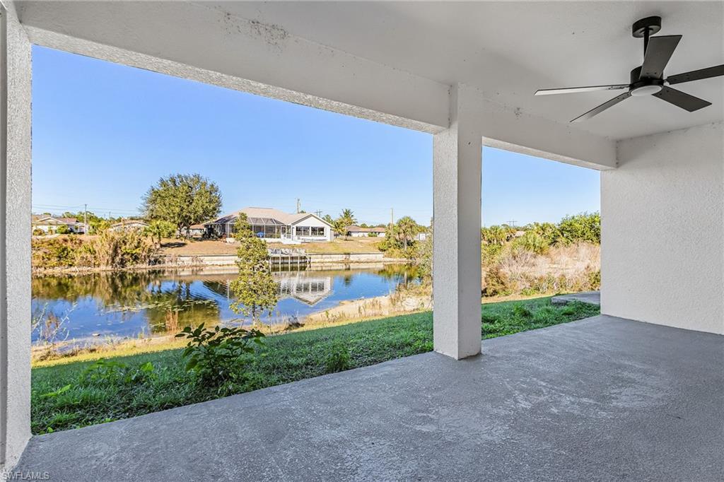 View of patio with a ceiling fan, a water view, and a residential view