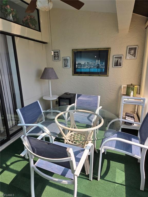 Balcony featuring ceiling fan and outdoor dining area